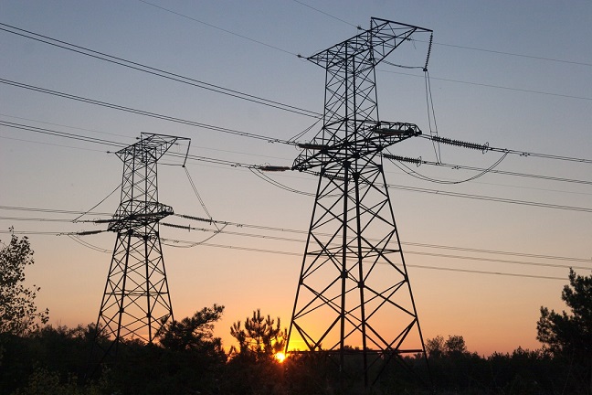 Power pylons and the setting sun